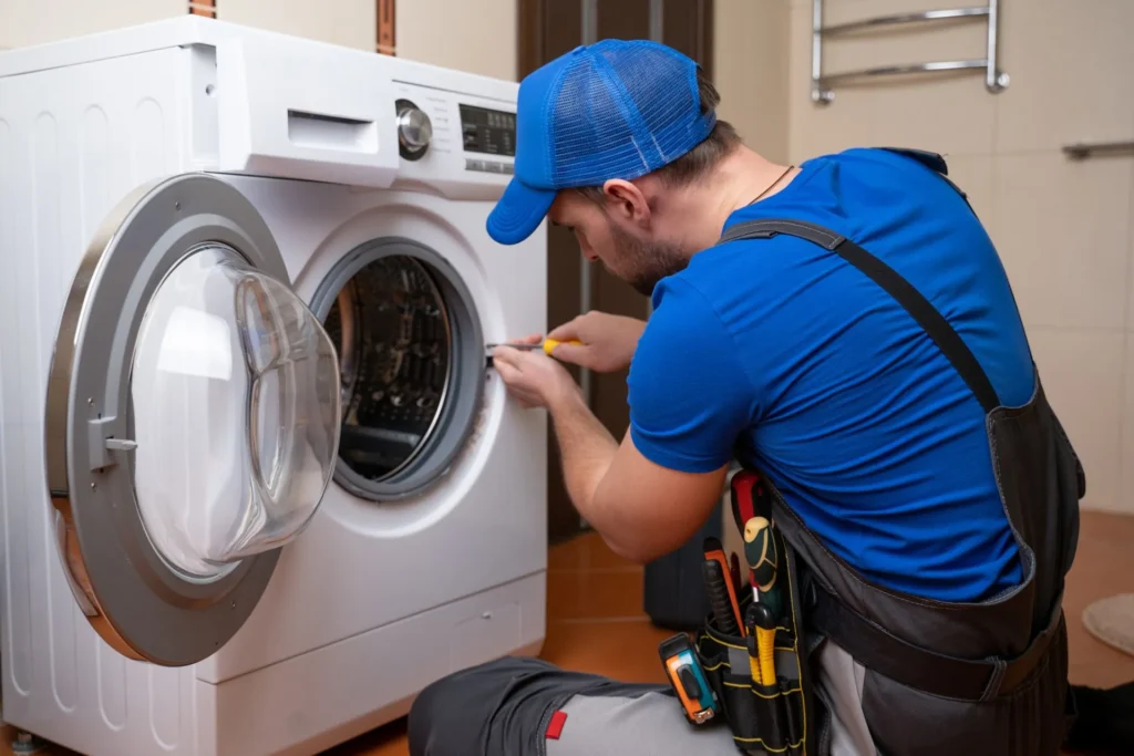 Technician providing washing machine repair services for home appliances