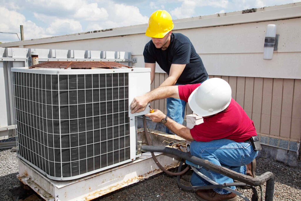 Technicians performing AC installation services for cooling systems